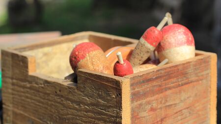 Old wooden box with fishing floatsの写真素材