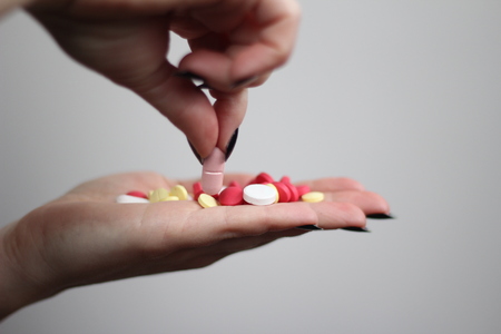 Taking pills from the handの写真素材