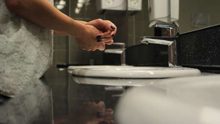female hands over the sink in a public restroomの写真素材