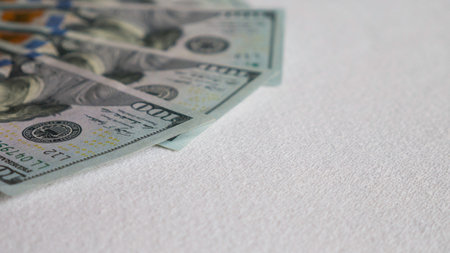 Banknotes of hundred dollars on a white background