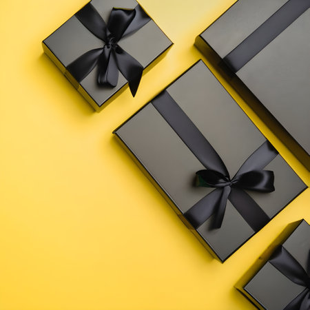 Black gift boxes on yellow background. Flat lay, top view.の素材