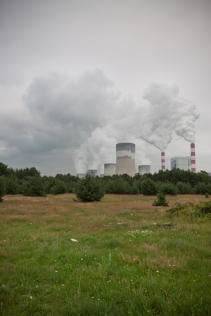 green forest with huge electro station with smoke over のeditorial素材