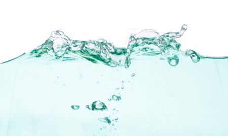green water wave with bubbles on white backgroundの写真素材
