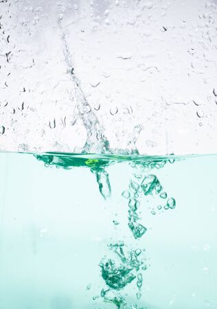 green water wave with bubblesの写真素材