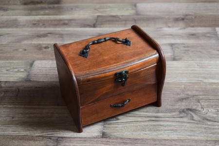 Wooden jewelry box with jewelry on the floorの写真素材