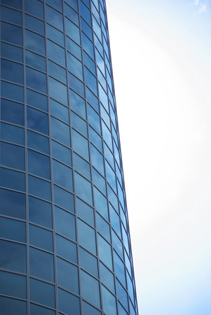 Modern building glasses with sky reflection