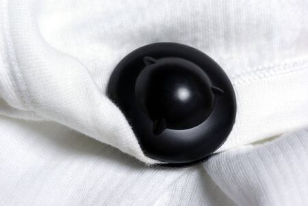 Black magnetic anti-shoplifting tag on the clothing.の写真素材