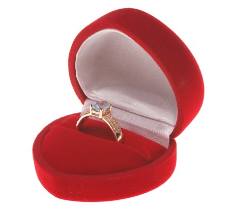 Red heart (jewellery box) with a golden ringの写真素材