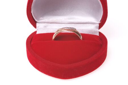 Golden ring inside a gift box (heart shape)の写真素材