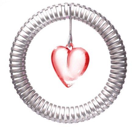 Red heart inside steel spiral circleの写真素材