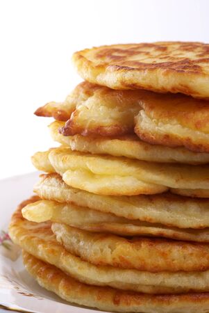 Stack of cheesy pancakes on the white background.の写真素材