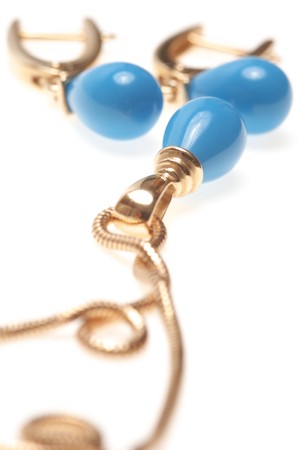 Golden earrings and pendent, isolated on white.の写真素材