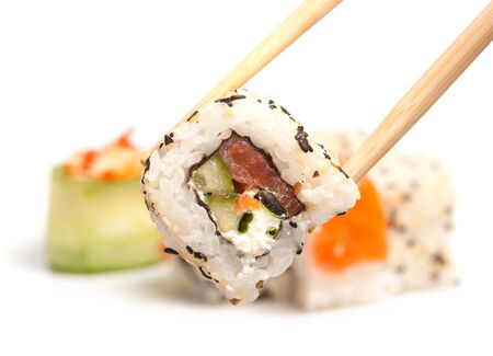 Took a sushi roll by the chopsticksの写真素材