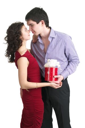 Attractive young couple with a gift in hands isolated on the white backgroundの写真素材