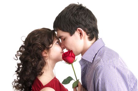 Portrait of beautiful couple with red rose isolated over white backgroundの写真素材