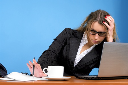 Tired businesswoman in the officeの写真素材