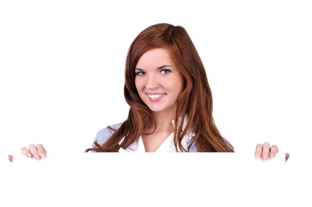 Beautiful young woman holding an empty billboard over white backgroundの写真素材