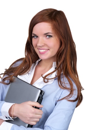 College girl carrying a laptop with a cute smile over white backgroundの写真素材