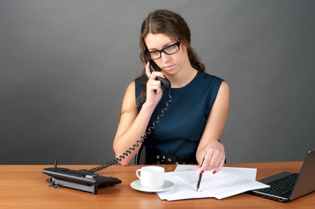 Portrait of businesswoman talking phone in the officeの写真素材