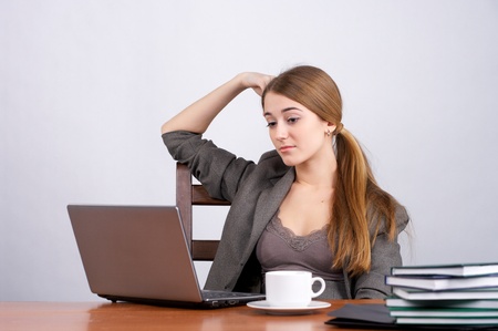 Young female executive working on laptop in the officeの写真素材