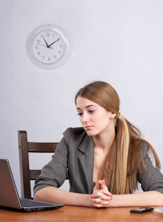 Serious businesswoman working on laptop at officeの写真素材