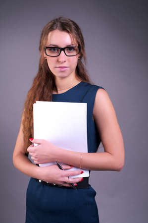 Cute businesswoman holding a documentsの写真素材