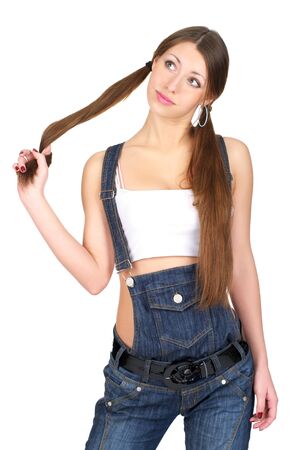 Sensual woman in denim overalls over white backgroundの写真素材