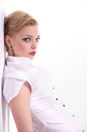 Fashion Portrait of beautiful woman leaning against the wallの写真素材