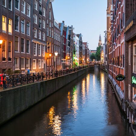 Amsterdam cityscape along one of cannals and the De Oude Kerk Towerのeditorial素材