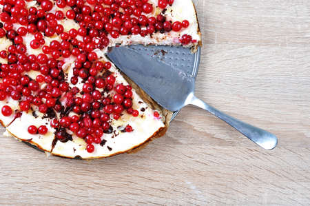 Curd pie with red currant on a wooden tableの写真素材