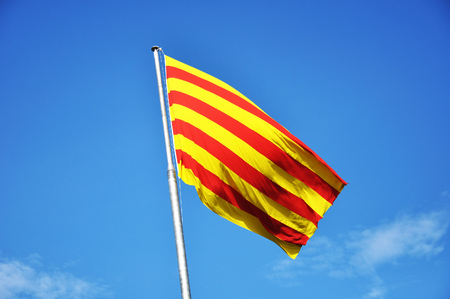 Flag of Catalonia against blue skyの写真素材