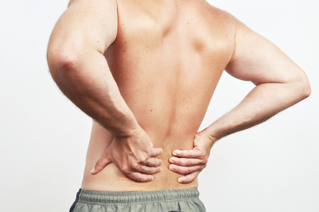 Man having a backache isolated on whiteの写真素材