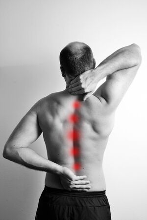 Man having a backache isolated on whiteの写真素材