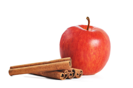 Apple and cinammon sticks isolated on whiteの写真素材