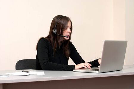 Business woman with laptop and headsetの写真素材