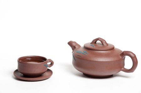 Clay tea pot: kettle and cut with green teaの写真素材