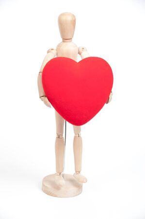 Wood man with big red heart isolated on white backgroundの写真素材