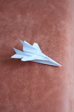 Paper plane model. Origami. Handmade paper plane. Travel concept. White paper plane model.の写真素材