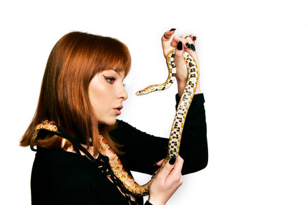 Beautiful woman in black bodywear and snake. Ginger model girl with fashion perfect make up.
