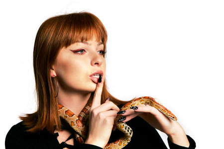 Beautiful woman in black bodywear and snake. Ginger model girl with fashion perfect make up. High...