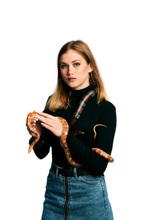 Beautiful woman in black bodywear and snake. Blonde model girl with fashion perfect make up.