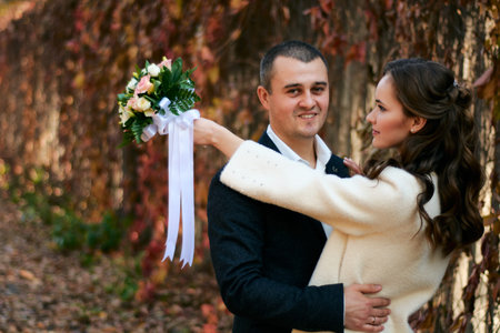 Couple in love close-up portrait. Young male and woman just married. Concept of happy family. Modern family outdoor. Adorable family demonstrate love and care. Autumn vacation.の写真素材