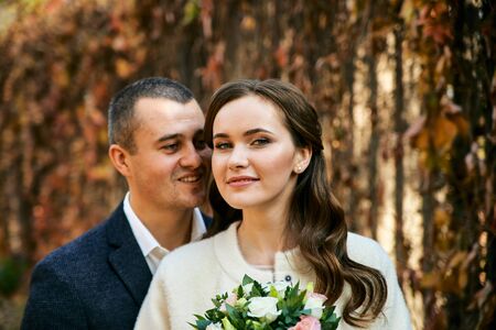 Couple in love close-up portrait. Young male and woman just married. Concept of happy family. Modern family outdoor. Adorable family demonstrate love and care. Autumn vacation.の写真素材