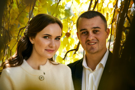 Couple in love close-up portrait. Young male and woman just married. Concept of happy family. Modern family outdoor. Adorable family demonstrate love and care. Autumn vacation.の写真素材