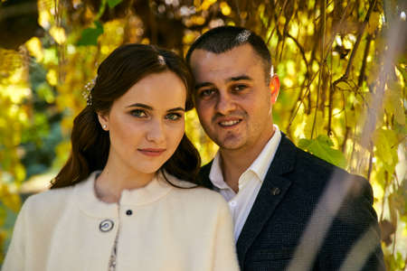Couple in love close-up portrait. Young male and woman just married. Concept of happy family. Modern family outdoor. Adorable family demonstrate love and care. Autumn vacation.の写真素材