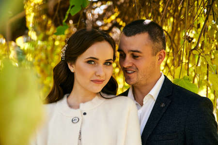 Couple in love close-up portrait. Young male and woman just married. Concept of happy family. Modern family outdoor. Adorable family demonstrate love and care. Autumn vacation.の写真素材