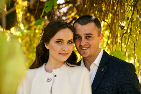 Couple in love close-up portrait. Young male and woman just married. Concept of happy family. Modern family outdoor. Adorable family demonstrate love and care. Autumn vacation.の写真素材