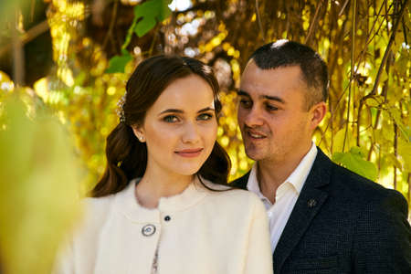 Couple in love close-up portrait. Young male and woman just married. Concept of happy family. Modern family outdoor. Adorable family demonstrate love and care. Autumn vacation.の写真素材