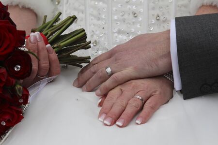 Bride and groom holding handsの写真素材