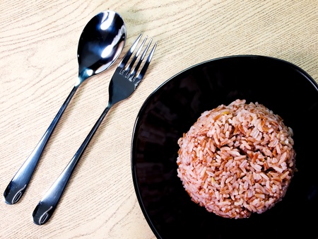 Brown rice with a spoon and fork の写真素材